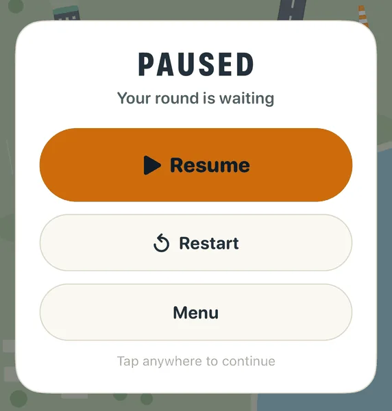 The pause card over a faded airfield: the word PAUSED, then the buttons Resume, Restart and Menu.